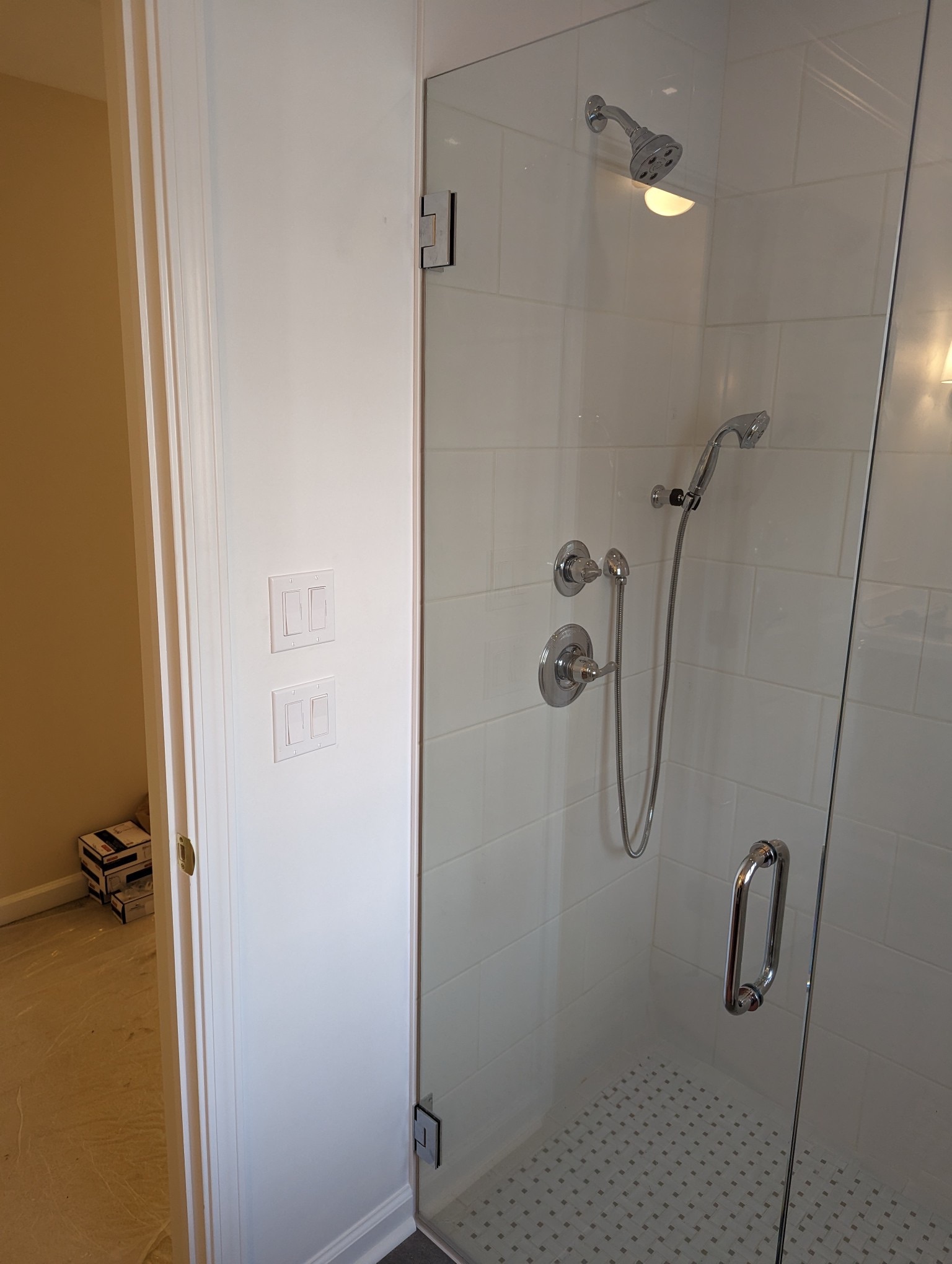 Classic white tile shower with frameless glass door